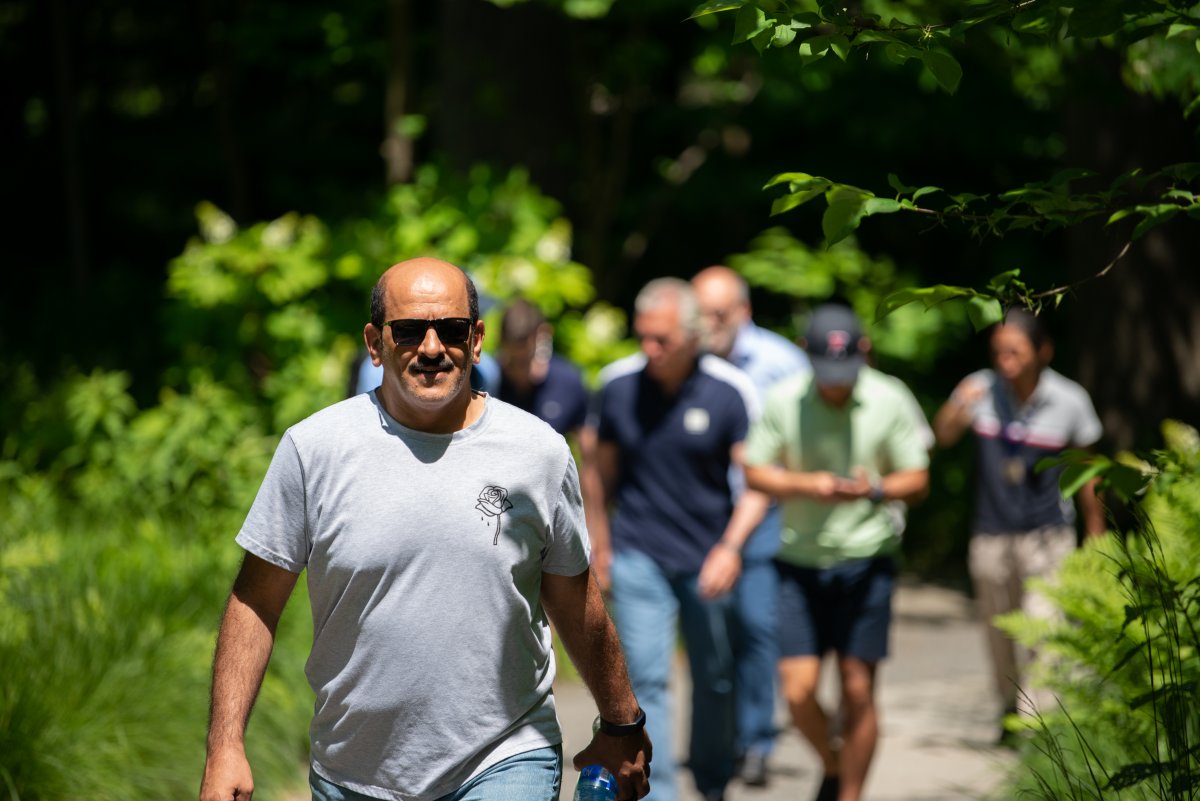 Participants in the Wharton Executive Education Advanced Management Program walking around Longwood Gardens on their retreat. 