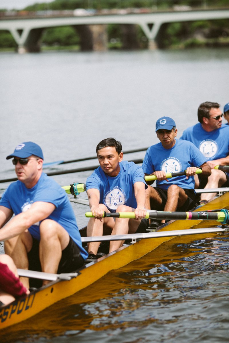 Participants in the Wharton Executive Education Advanced Management Program rowing on the Schuylkill River