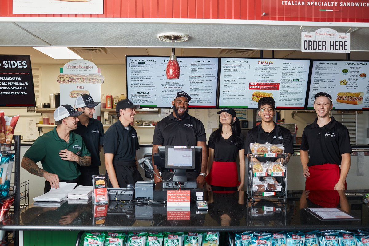 Brandon Graham behind the counter of Primo Hoagies with the staff. 