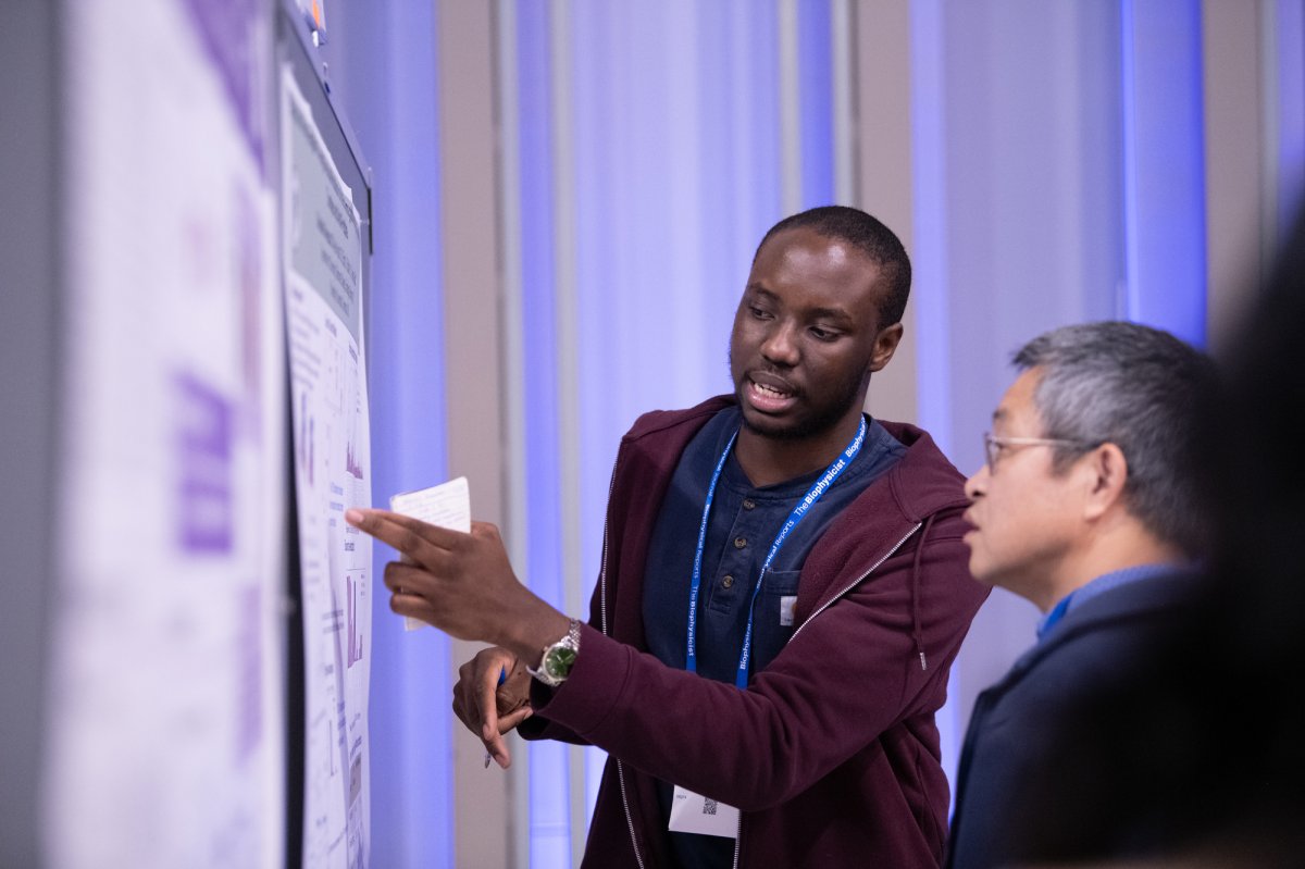 biology and physiology students explain their posters during the conference